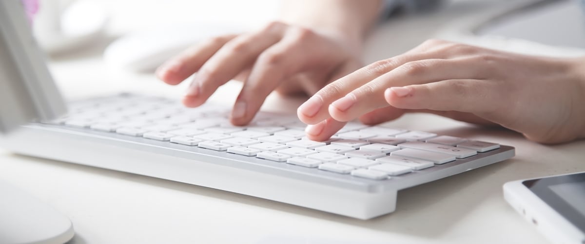 person typing on a keyboard