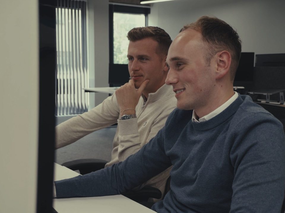 Two members of the Techquity team working together